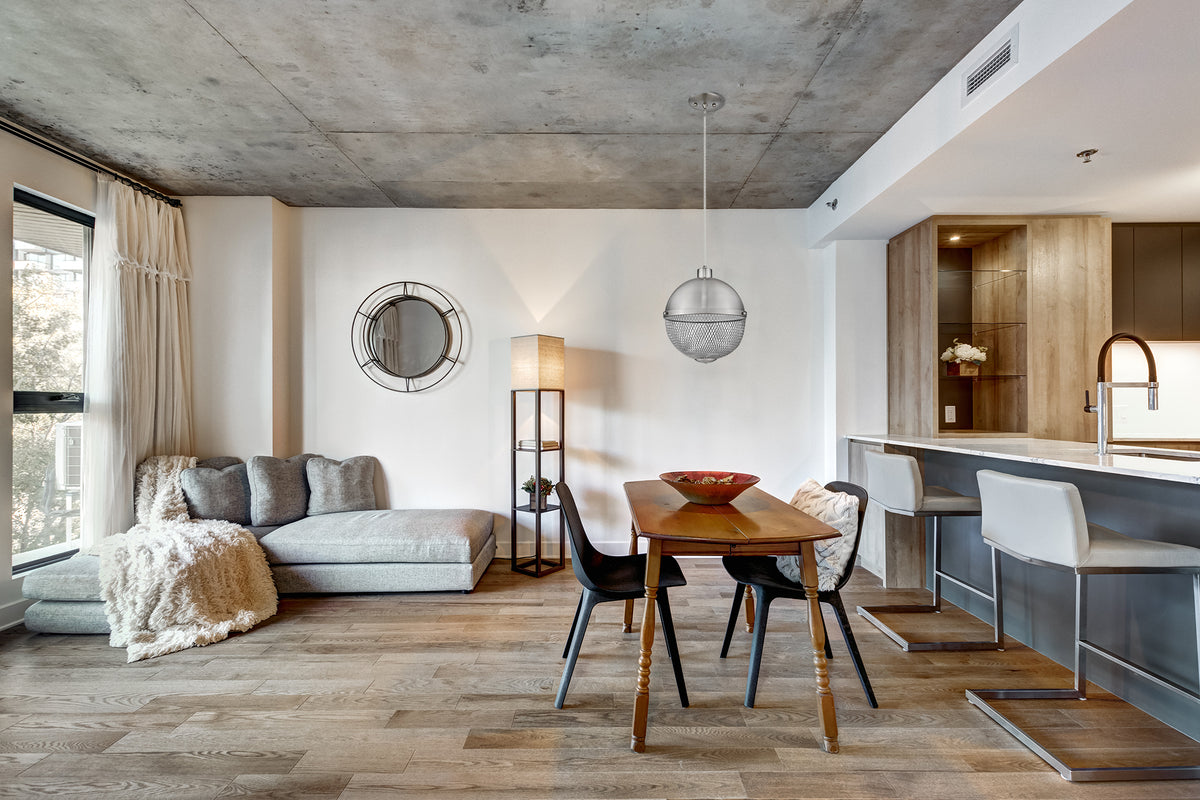 Metal mesh pendant light fixture hanging over table